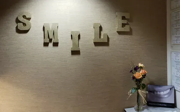 Wooden letters spelling SMILE on the wall.
