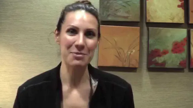 A Cooley Smiles patient speaking to camera in the practice consultation room.